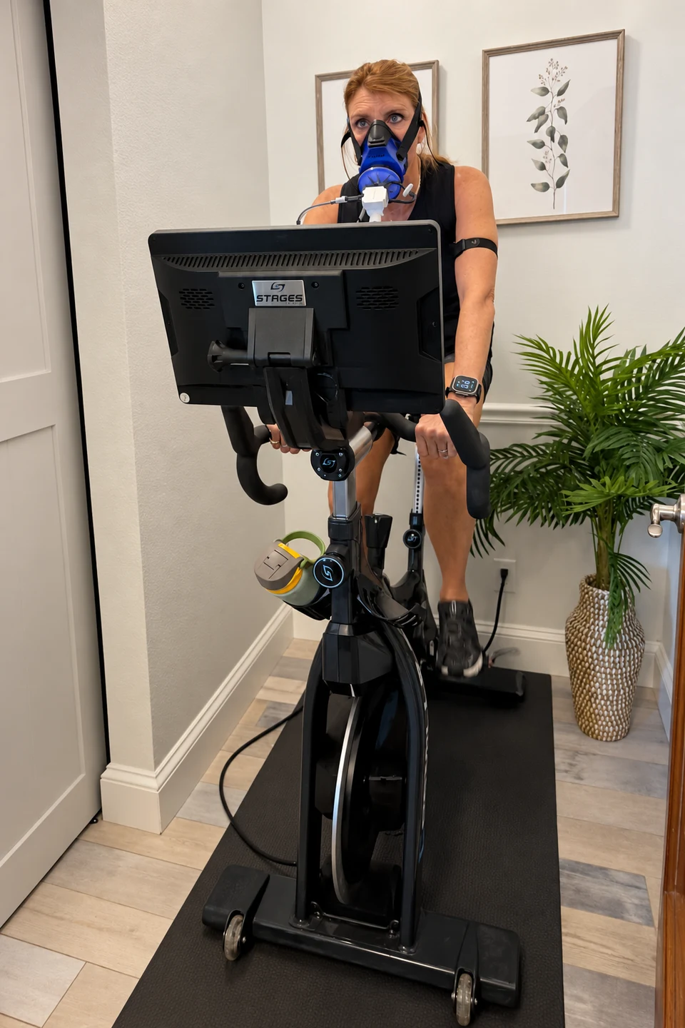 A guest completing a PNŌĒ exercise assessment on the studio bike