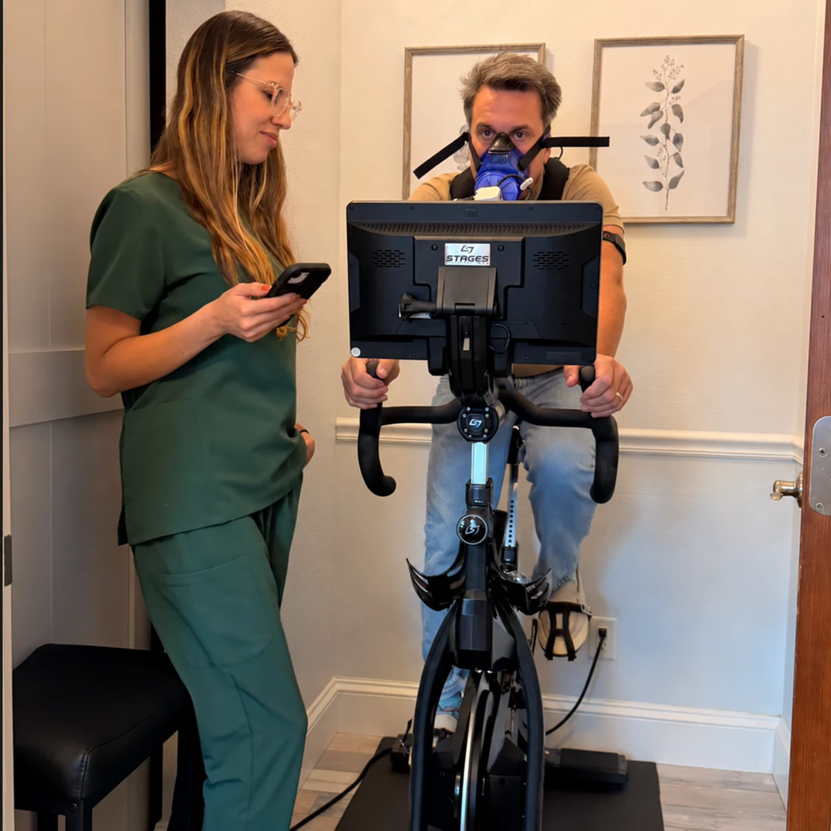 Thaysa guiding a guest through PNŌĒ exercise testing on the studio bike